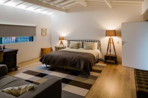 - une chambre avec un grand lit et un canapé dans l'établissement casasun777, deixe-se surpreender e deslumbrar!, à Braga