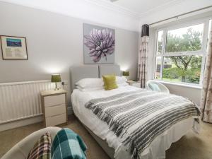 a bedroom with a large bed and a window at Muriau Park in Caernarfon