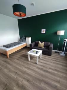 a living room with a couch and a coffee table at Cityapartment in Stadtlohn