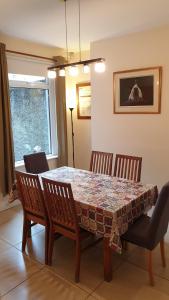 a dining room table with four chairs and a table and a table and chairsktop at Titanic History Private Home in Belfast