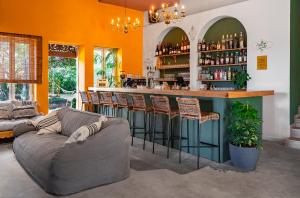 a living room with a couch and a bar at Mantur Jerusalem Mountains by Selina in Ma'ale HaHamisha