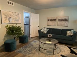 a living room with a couch and a table at HHI Homes- Newly Renovated Cozy Modern Pet-Friendly Villa-Ideal Location in Hilton Head Island