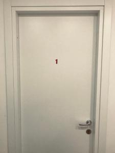 a white door with a red number one on it at WelcomeRomaB&B in Rome
