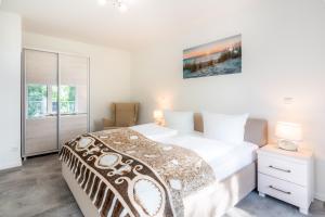 a bedroom with a large bed and a window at Apartment "Haffblick" - Haffresidenz in Garz +15 photos
