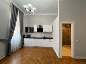 a kitchen with white cabinets and a chandelier at 1501 Wergass 18 in Sibiu