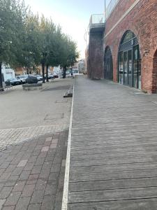 an empty sidewalk next to a brick building at The Wellington Restaurant and Bar in Portsmouth