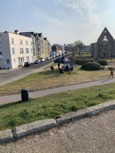 a group of people in a park with a blue tent at The Wellington Restaurant and Bar in Portsmouth