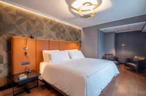 Posteľ alebo postele v izbe v ubytovaní Pullman Santiago Vitacura