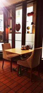 een houten tafel en stoelen in een kamer bij Atelier Hotel Essen-City in Essen