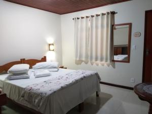 Cama ou camas em um quarto em Pousada Caminho das Candeias