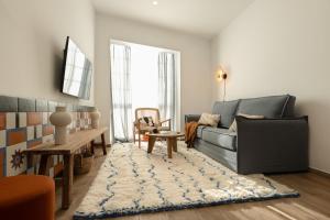 a living room with a couch and a rug at Attic Oasis in Málaga