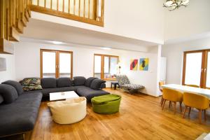 a living room with a couch and a table at Mountain Top Deluxe + free garage parking in Bjelašnica