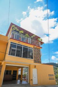 a yellow house with plants on the top of it at Casa LEONOR in Oaxaca City
