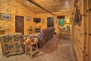 a living room with a couch and a table at Updated Manistique Log Cabin, Yard and Fire Pit in Manistique