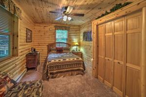 a bedroom with a bed in a log cabin at Updated Manistique Log Cabin, Yard and Fire Pit in Manistique