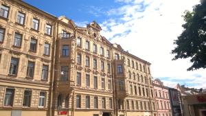 a large building with many windows on a street at Apartments near Mariinsky Theatre in Saint Petersburg