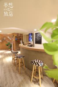 a restaurant with stools in front of a counter at Dream 12 Hotel in Taichung