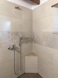 a bathroom with a shower with a shower head at Saxonis Houses & Saxonis Villa in Papigko