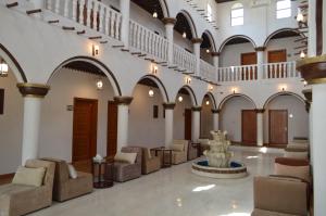 a lobby with chairs and a fountain in a building at Drwazet Nakheel Tourist Village in Al Hofuf