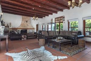 a living room with a couch and a fireplace at Anoud Manor in Hout Bay