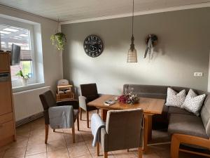 a living room with a table and a couch at Freimuth`s Hof in Südbrookmerland