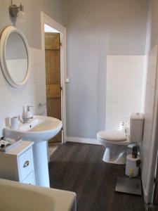 a bathroom with a sink and a toilet and a mirror at ChezLola in Civray