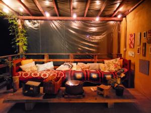 a living room with a couch on a stage at Hospedaria Vida na Roça in São Bento do Sapucaí
