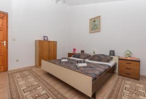 a bedroom with a large bed and a wooden floor at Holiday home Frane in Slivno