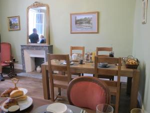a dining room with a table and a fireplace at ChezLola in Civray