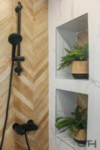 a plant holder in a bathroom next to a mirror at Luxury 80m2 apartment with balcony downtown Thessaloniki in Thessaloniki +99 photos