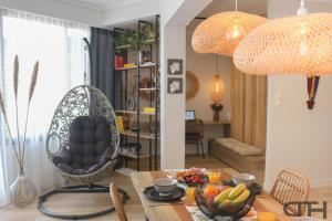 a living room with a chair and a table with fruits at Luxury 80m2 apartment with balcony downtown Thessaloniki in Thessaloniki