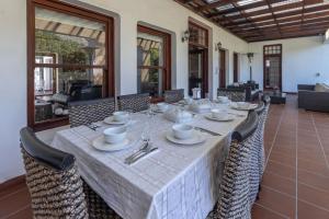 a dining room with a long table and chairs at Anoud Manor in Hout Bay