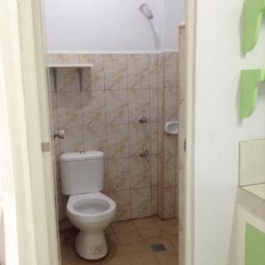 a small bathroom with a toilet and a shower at Lavarez Apartment in Lucena