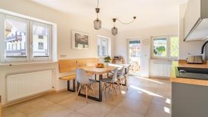 a kitchen and dining room with a table and chairs at Ferienhaus Achental in Schleching