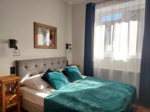 Posteľ alebo postele v izbe v ubytovaní 4 STRONY ŚWIATA Pokoje i Apartamenty