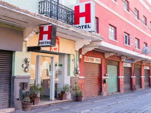 a row of stores on a city street at Hotel Río Puebla Centro in Puebla +40 photos