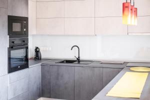 a kitchen with a sink and a stove top oven at Blue Sky in Čakovec