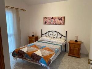 a bedroom with a bed and a painting on the wall at Sol y Mar in Tarajalejo
