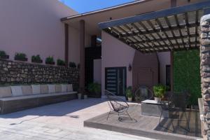 a patio with a bench and a table and chairs at San José Suites Boutique, Linares in Linares