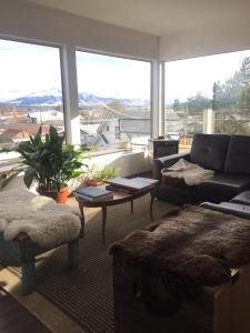 a living room with a couch and a table at Xalpen B&B in Puerto Natales