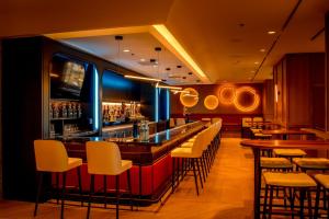 a bar in a restaurant with chairs and tables at Atlantica Hotel Halifax in Halifax