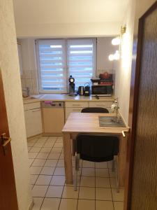 a kitchen with a wooden table and a counter top at Calabria Nr 3 in Mülheim an der Ruhr