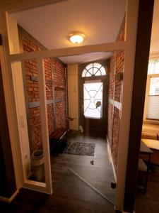 a hallway with a brick wall and a window at Barrierefreie Unterkunft - Fachwerk mit Flair in Osterode