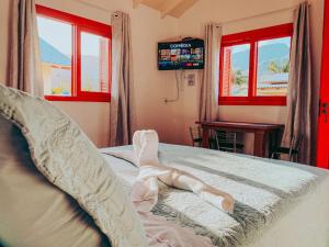a woman laying on a bed in a bedroom at Pousada Paredão dos Canyons in Praia Grande