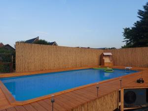 a swimming pool on top of a wooden deck at Ferienwohnung Uhlenbusch Paradise in Friesoythe