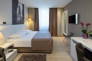 a hotel room with a bed and a desk at Cornaro Hotel in Split