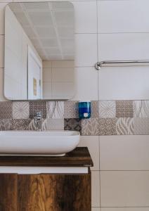 a bathroom with a sink and a mirror at AViSOS HOTEL & APARTMENTS in Marmaris +46 photos