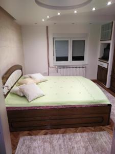 1 dormitorio con 1 cama en una habitación con ventana en BLAGOJEVIĆ, en Guča