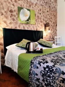 a bedroom with a bed with a black and green comforter at Hotel Victoria in Florence