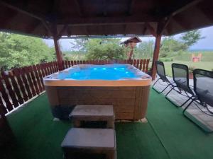 a large hot tub sitting under a gazebo at Apartment Feher Lendava in Lendava